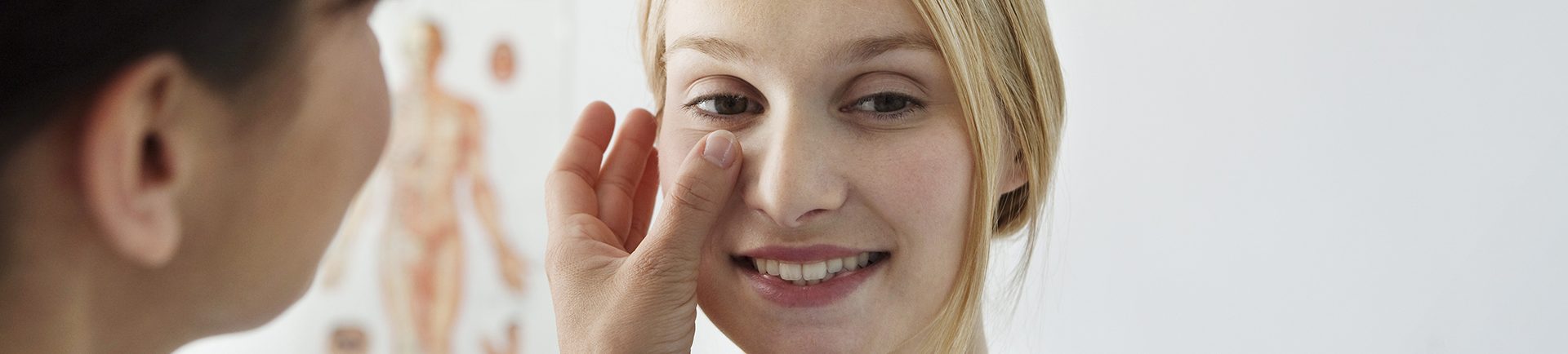 Cropped image of a patient having her skin evaluated by a doctor