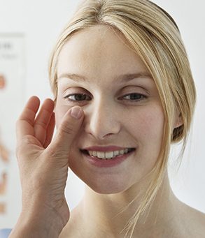 Patient smiling being checked by a dermatologist