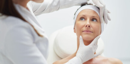 A scene of a doctor checking a patient's facial skin