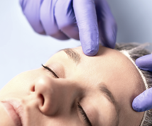 cropped image of a doctor checking a patient's skin