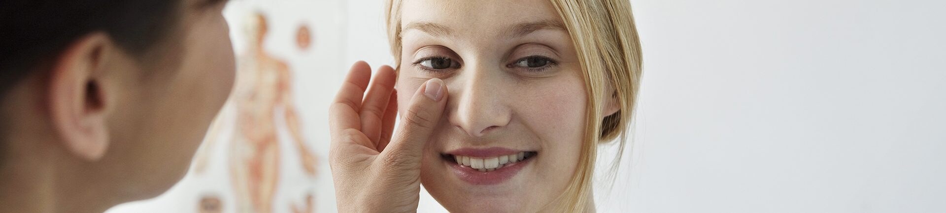 photo of a women being massaged under her eye
